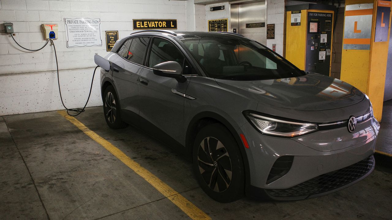 A Volkswagen ID.4 electric vehicle charges at an EV charging station.