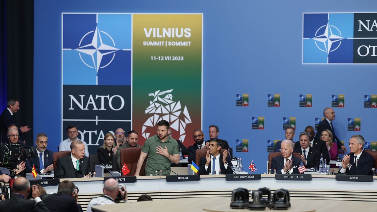 Ukrainian President Volodymyr Zelenskyy (2nd L) applauded by Turkish President Recep Tayyip Erdogan (L), Britain's Prime Minister Rishi Sunak (3rd R) and US President Joe Biden (2nd R) as he is introduced at a meeting of the NATO-Ukraine Council during the NATO Summit in Vilnius on July 12, 2023.