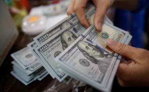 Dollar retreats ahead of key payrolls data