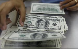 Dollar edges lower, but off 15-month lows after solid labor data