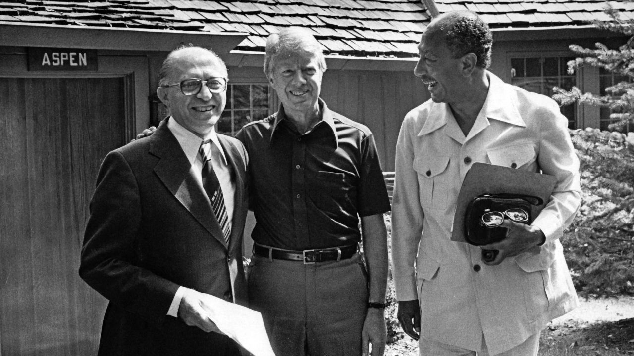 Portrait of from left, Israeli Prime Minister Menachem Begin (1913 - 1992), US President Jimmy Carter, and Egyptian President  Anwar Al Sadat (1918 - 1981) as they pose together during the Egyptian-Israeli peace negotiations, in front of Aspen Lodge at Camp David, near Thurmont, Maryland, September 12, 1978. The negotiations resulted in the 'Camp David Accords' which were formalized as the 'Egypt--Israel Peace Treaty' the following year, in Washington DC on March 26, 1979. (Photo by White House via CNP/Getty Images)