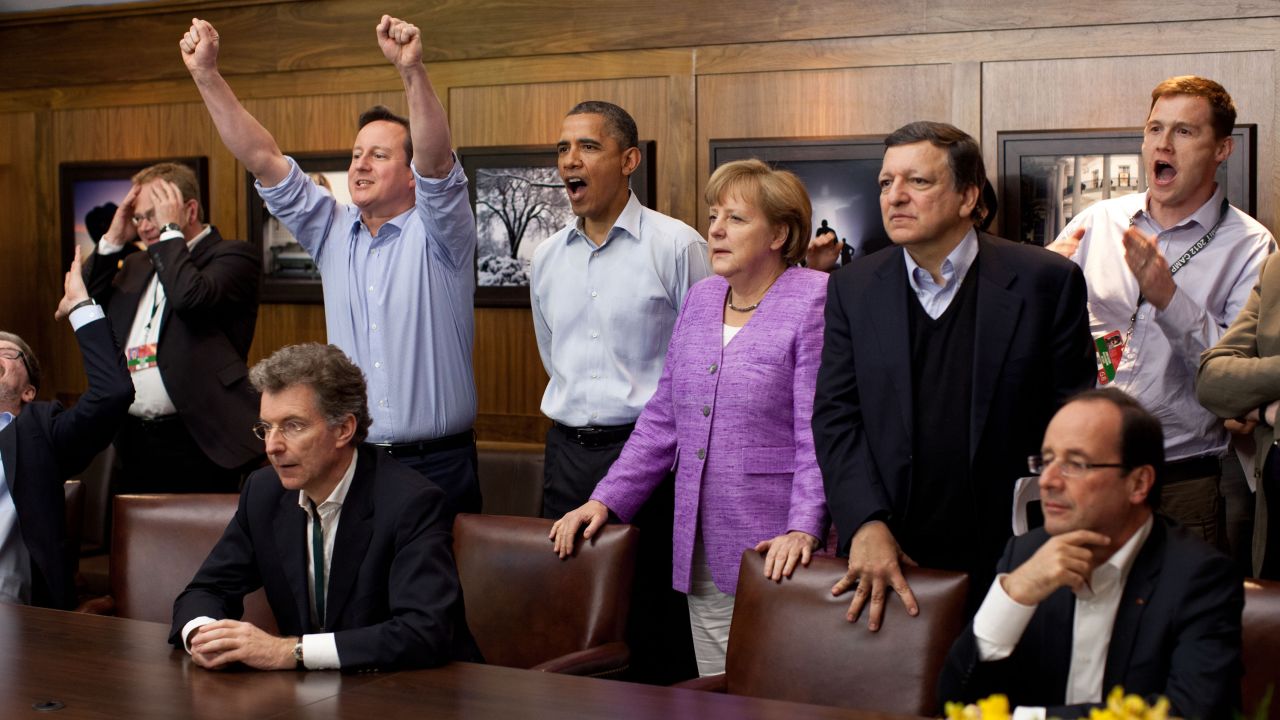 In this handout provided by The White House, Prime Minister David Cameron of the United Kingdom, U.S. President Barack Obama, Chancellor Angela Merkel of Germany, Jose Manuel Barroso, President of the European Commission, and others watch the overtime shootout of the Chelsea vs. Bayern Munich Champions League final in the Laurel Cabin conference room during the G8 Summit on May 19, 2012 at Camp David, Maryland. 