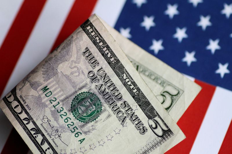 Dollar edges lower after Fitch downgrade; economic data points to recovery