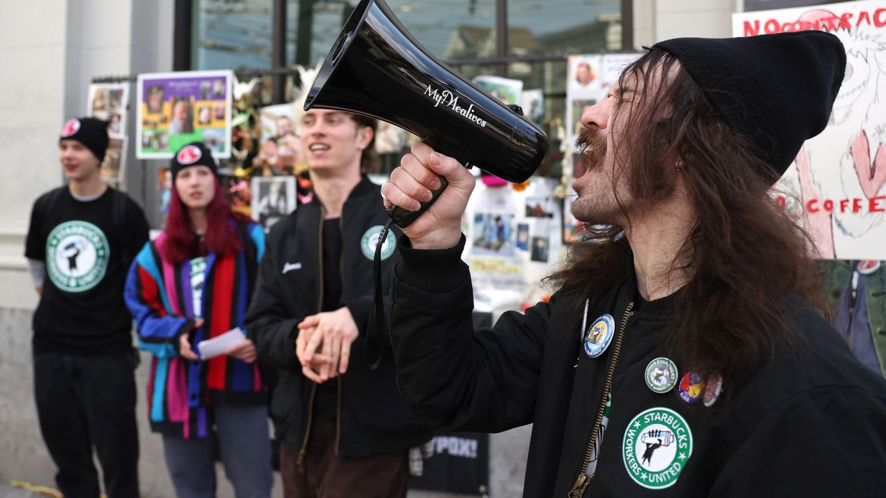 Workers gather outside of a Starbucks coffee shop during a national strike on November 17, 2022 in San Francisco, California.