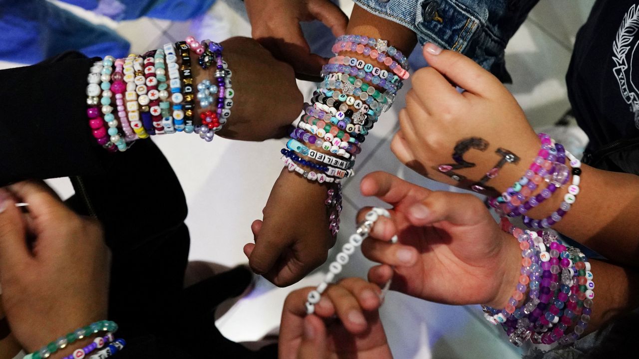 Teenagers trade bracelets while waiting for the beginning of Taylor Swift's Eras Tour concert movie in a cinema in Mexico City, Mexico October 13, 2023.